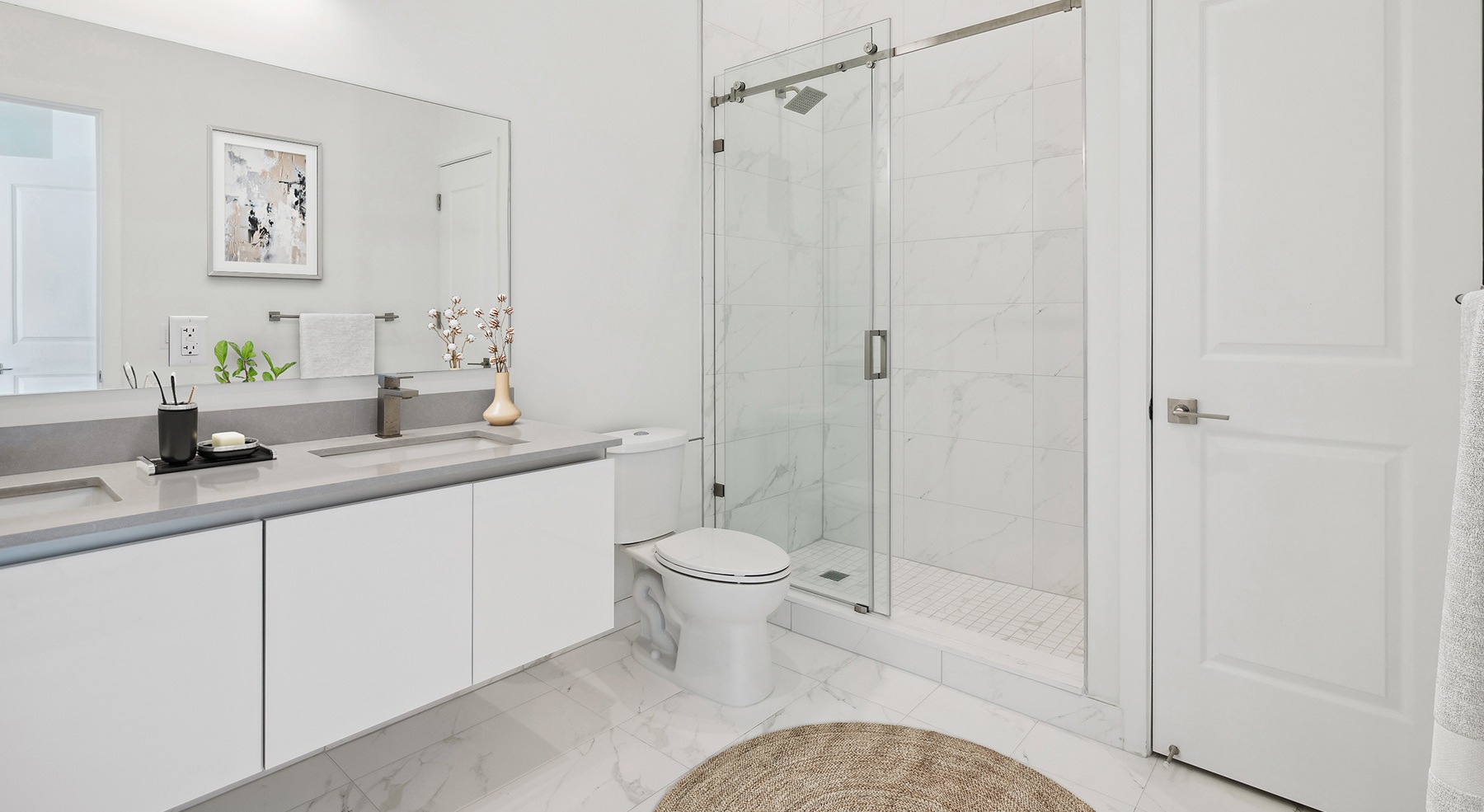 bathroom with a large mirror and shower with glass doors
