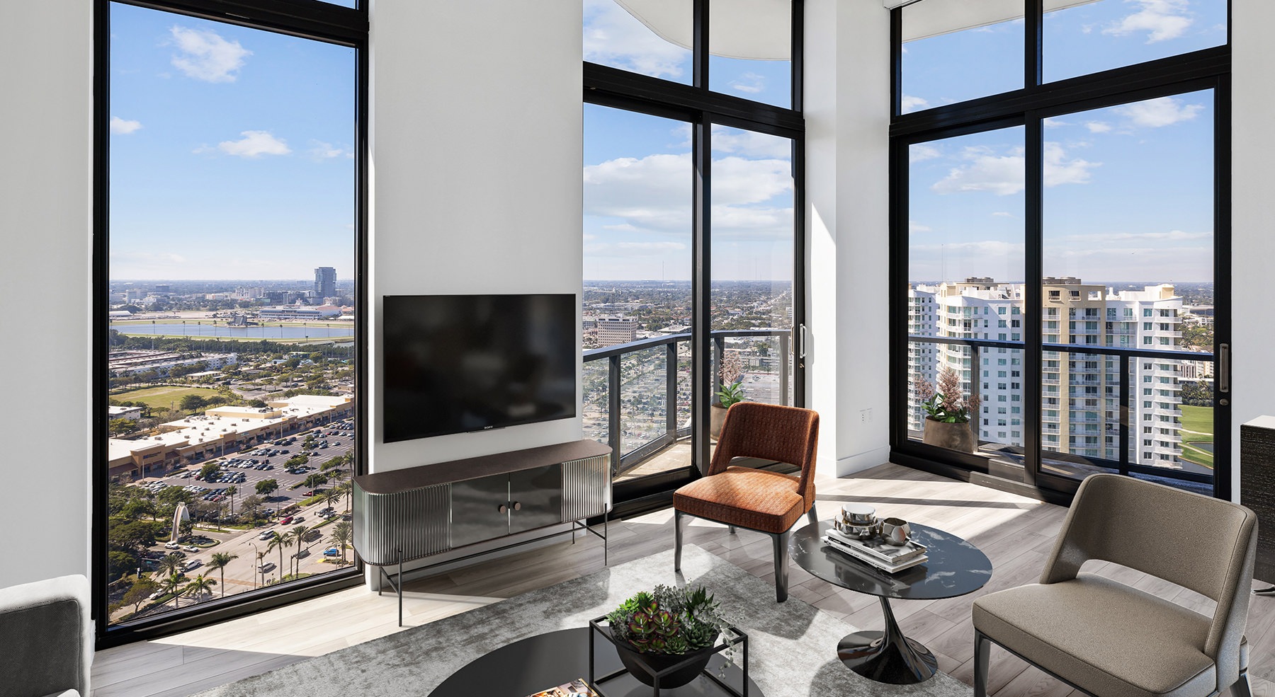 living room with chairs and large windows